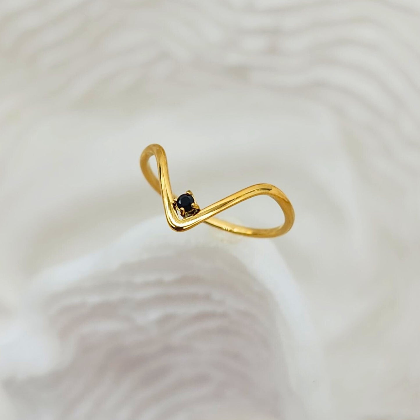 Minimalist gold V-shaped ring with petite black onyx stone, side angle