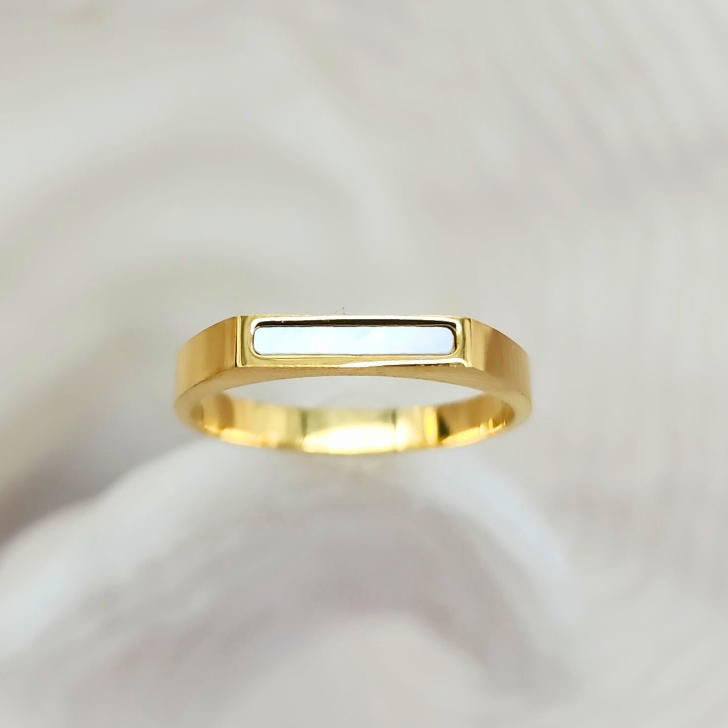 Front-facing gold bar ring with rectangular white seashell inlay, flat top design