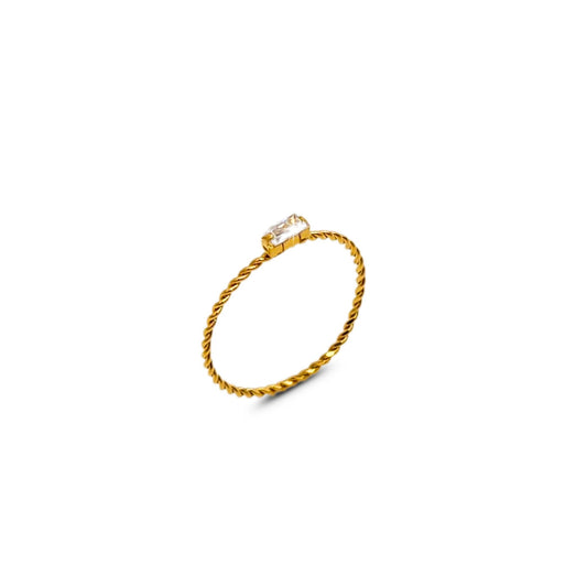 Minimalist twisted gold band ring with rectangular clear CZ stone, isolated on white