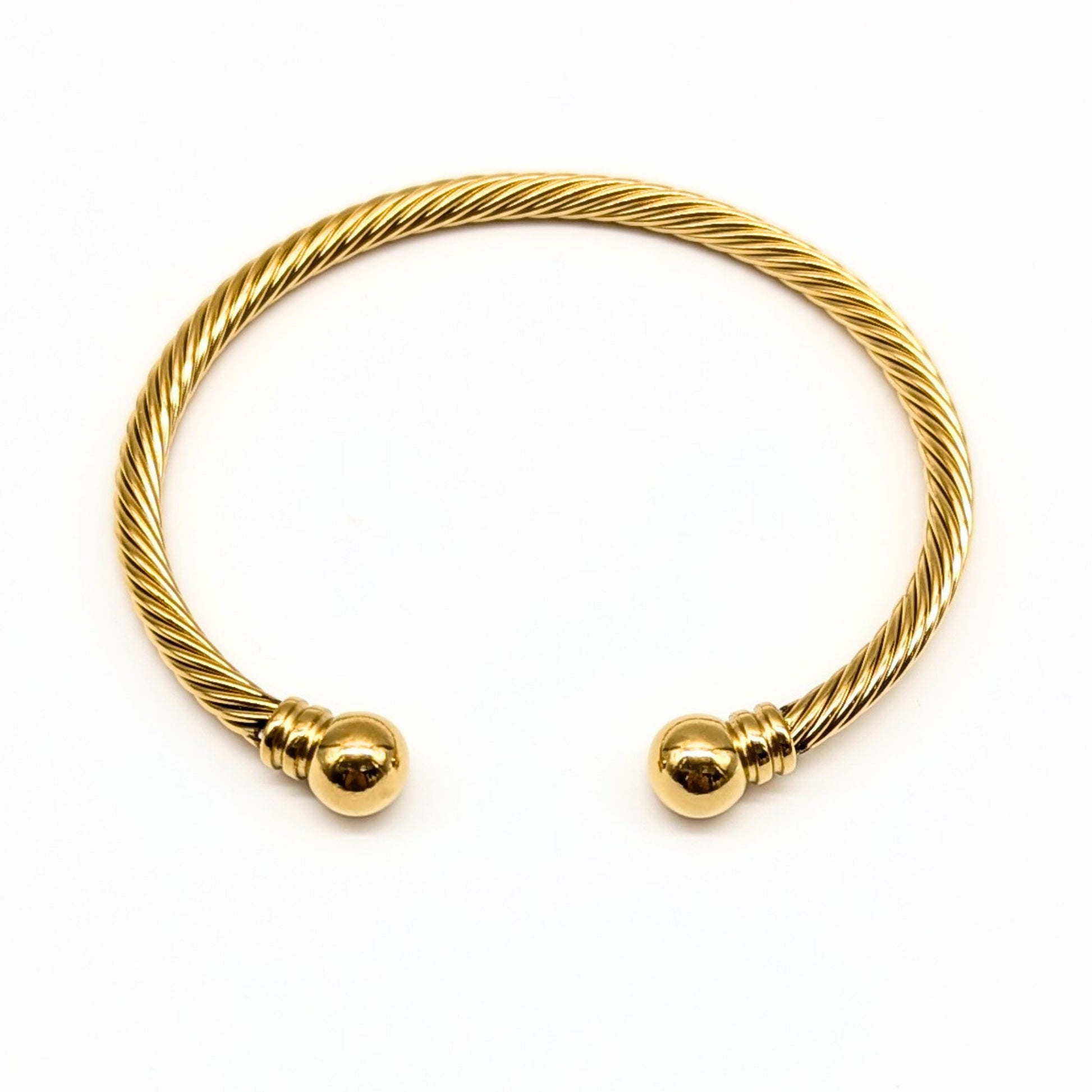Gold cable cuff bracelet with polished dome ends