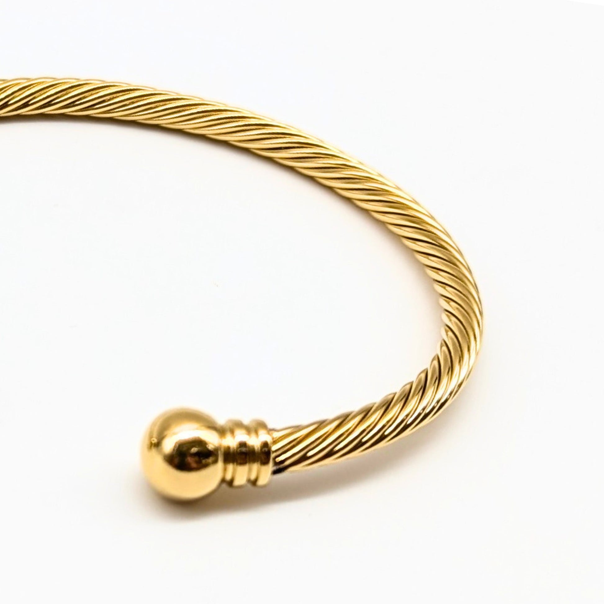 Elegant gold cuff bracelet on white background