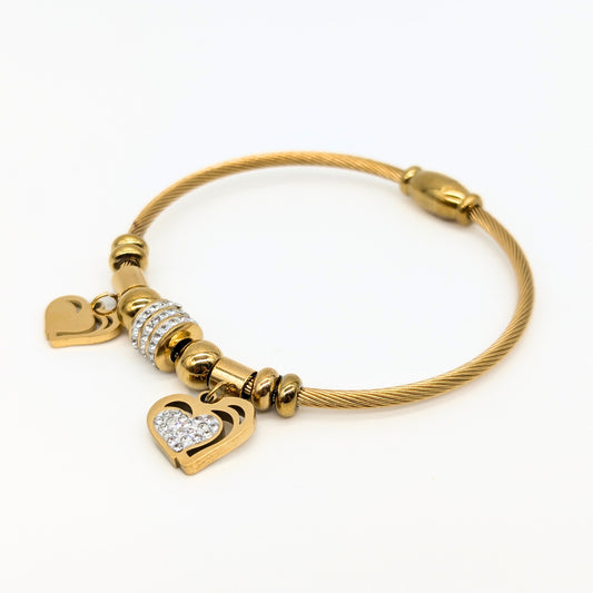 Gold bracelet with heart-shaped charms on a white background