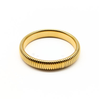 Gold single coil bracelet with polished ridged texture