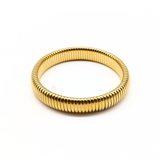 Gold single coil bracelet with polished ridged texture