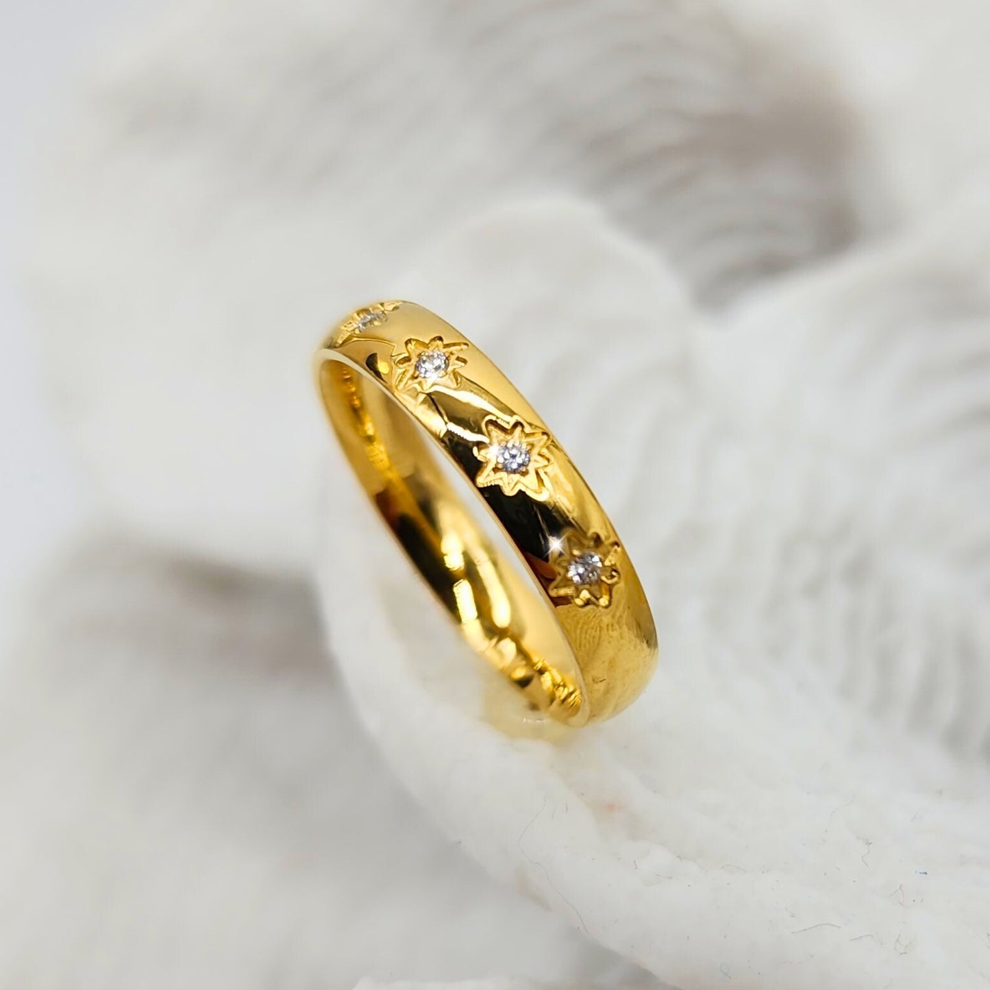Sleek gold band with engraved sunburst and crystal gemstones