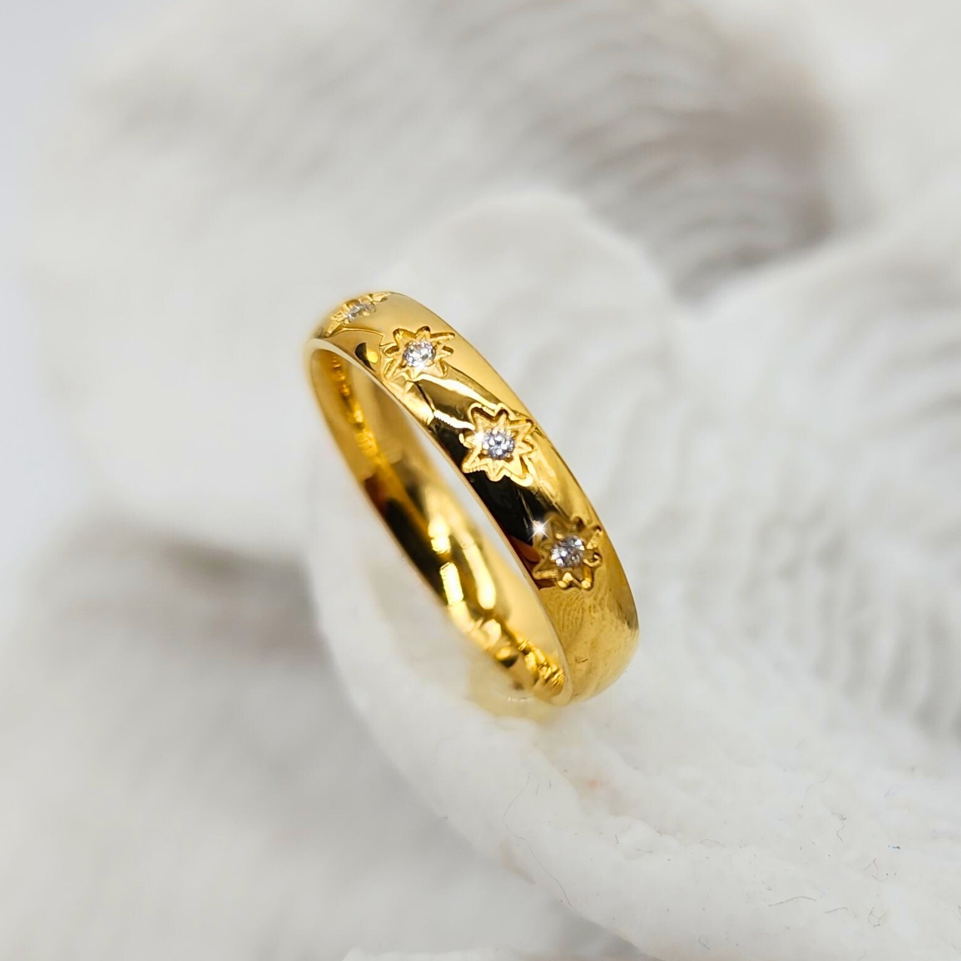 Sleek gold band with engraved sunburst and crystal gemstones