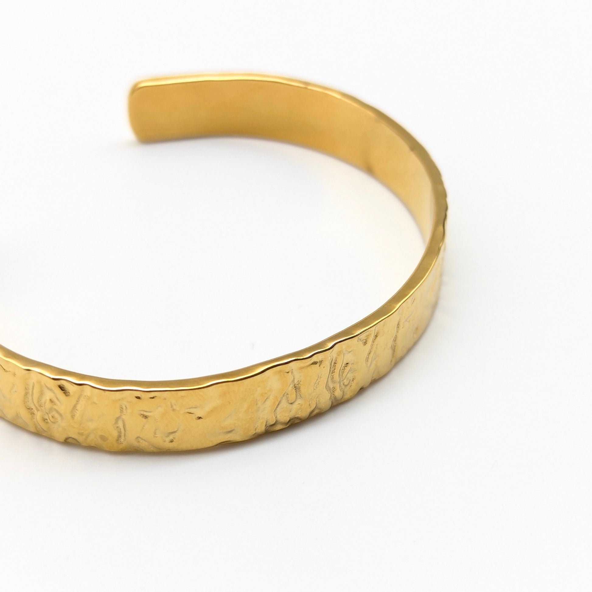 Textured Gold bracelet on a white background